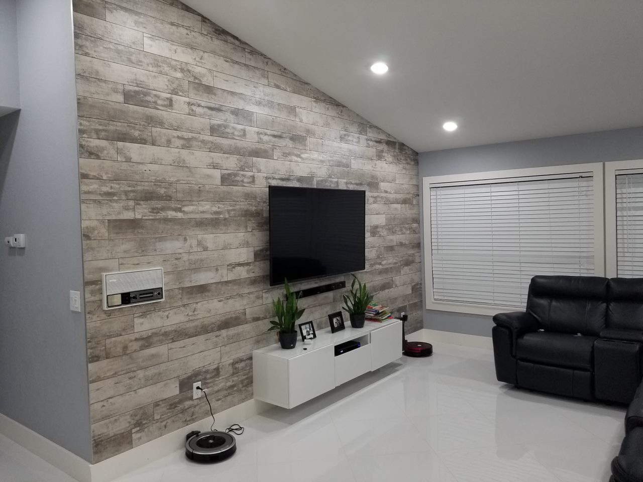 Boca Raton living room with stone accent wall and media console