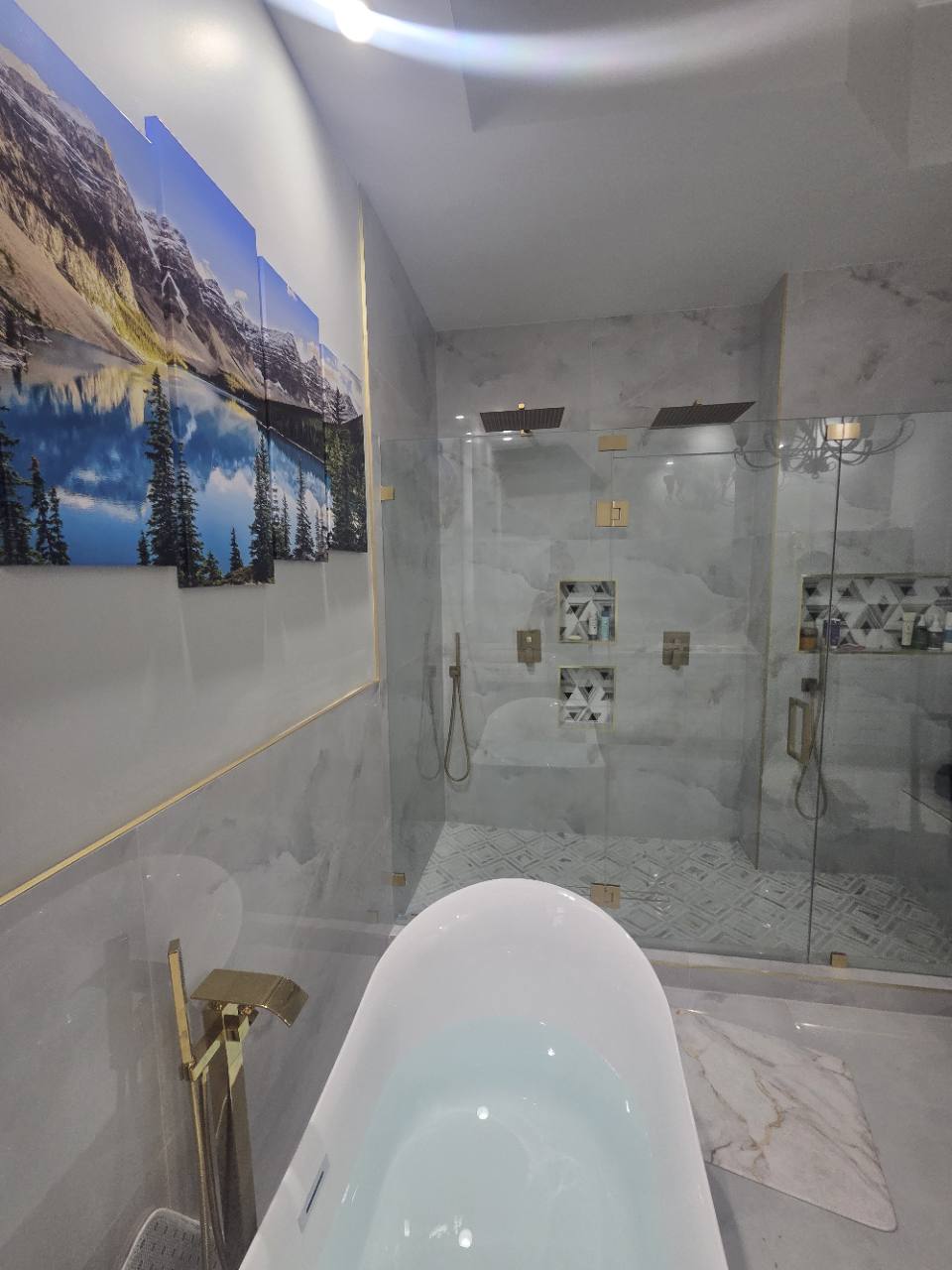 Finished bathroom with a freestanding tub, glass shower, and gold-tone fixtures