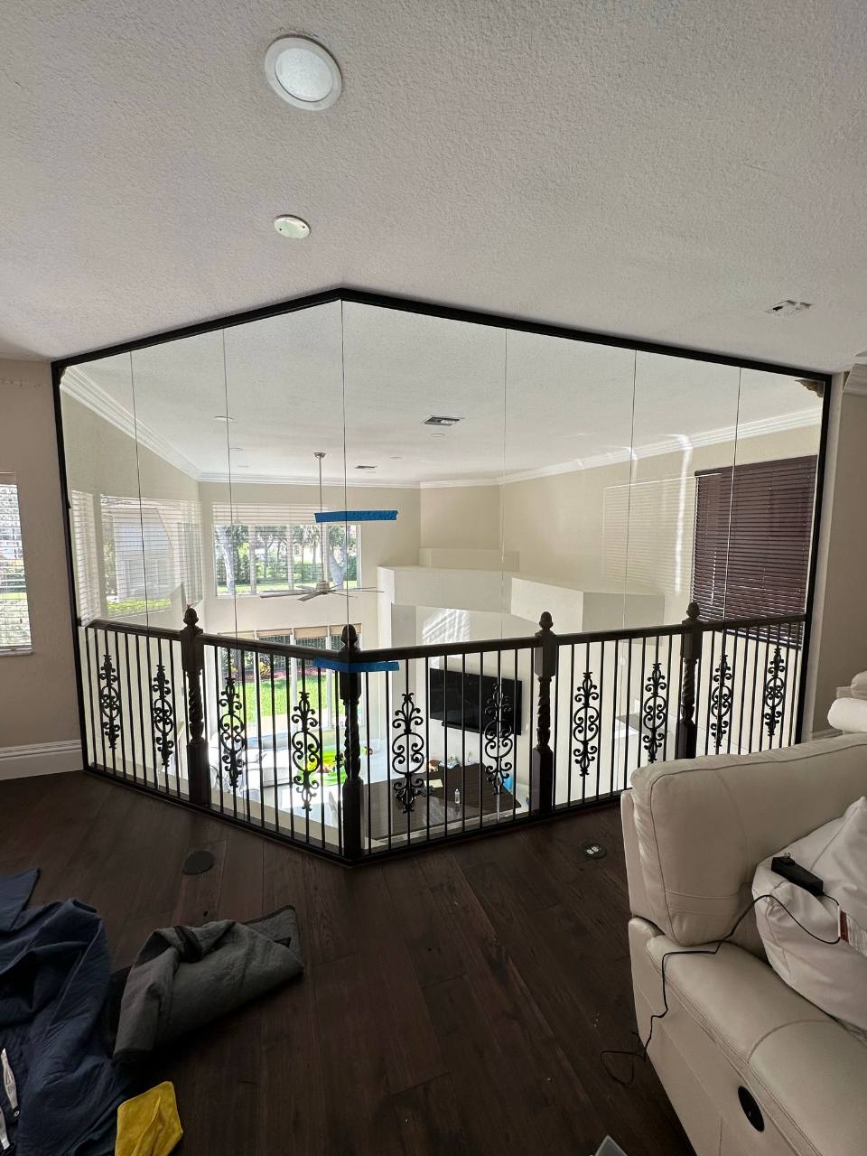 The same living-room glass enclosure during installation, with protective tape visible