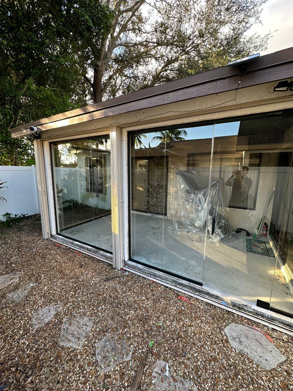 Patio glass enclosure viewed from the garden during renovation