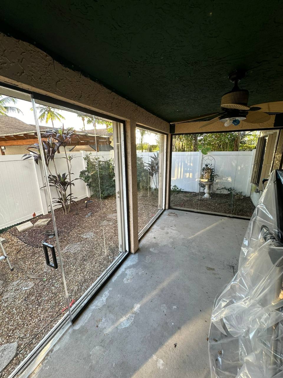 Interior view of the patio glass enclosure with unfinished flooring