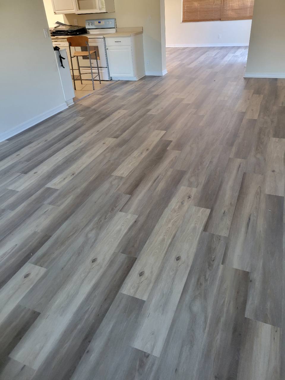 Light wood-look flooring connecting the living and dining areas